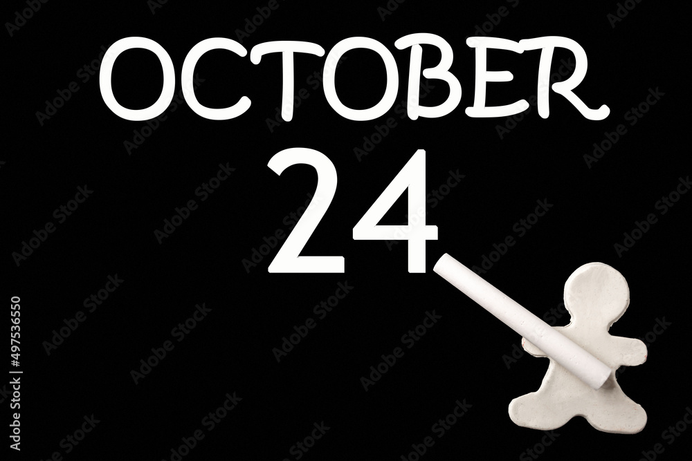 A small white plasticine man writing the date 24 October on a black board. Business concept. Education concept. A small white plasticine man writing the date 24 October on a black board. Business concept. Education concept.