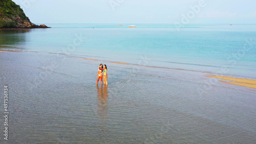 Beautiful shot of two Caucasian pretty females in bikini in the watersea, Koh Samui, Thailand photo