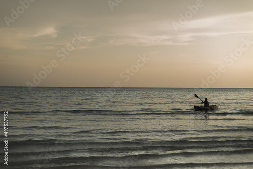 shot of kayak in calm blue sea on orange sunset background. Landscape Seascape, Amazing beach scene vacation and summer holiday concept. Luxury travel. background and copy space.