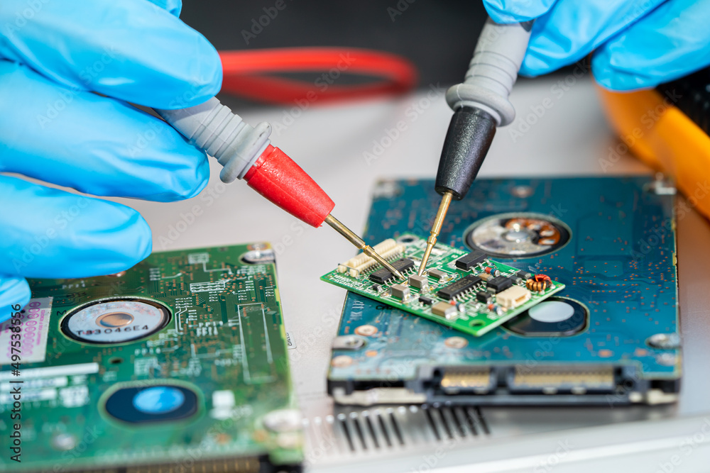 Naklejka premium Technician repairing inside of mobile phone by soldering iron. Integrated Circuit. the concept of data, hardware, technology.