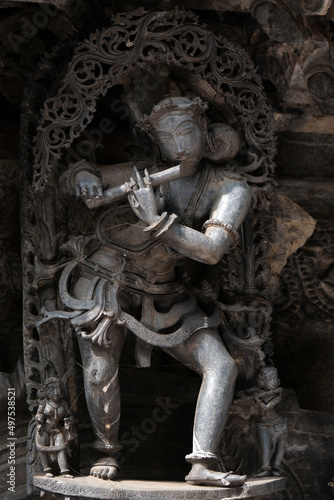 Stone Sculpture of Beautiful Female (Madanikas) with selective focus, 12th century Hindu temple, Ancient stone art and sculptures in each pillars, Chennakeshava Temple, Belur, Karnataka, India.