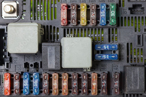 Automotive fuses on a black panel with holders and multi-colored markings - a protective device that opens the electrical circuit when the rated current in the circuit is exceeded. Electrical Repair photo