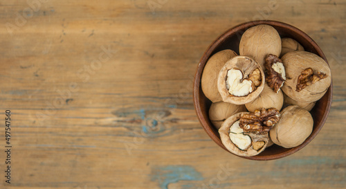 bowl full of delicious and fresh walnuts on an old wooden table
