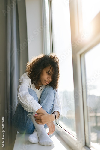 Depressed african American young woman sit at home feel desperate down suffering from relationships problems breakup  upset girl crying having life troubles         