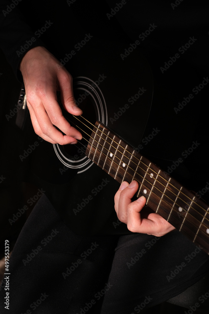 Fototapeta premium professional musician playing guitar close-up of hands