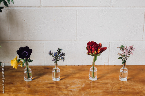 flowers in tiny liquor bottles photo