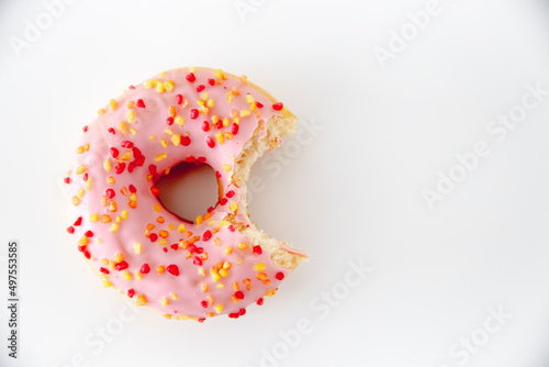 Εκτύπωση καμβά Closeup of a bitten pink glazed donut isolated on a white background with copy s