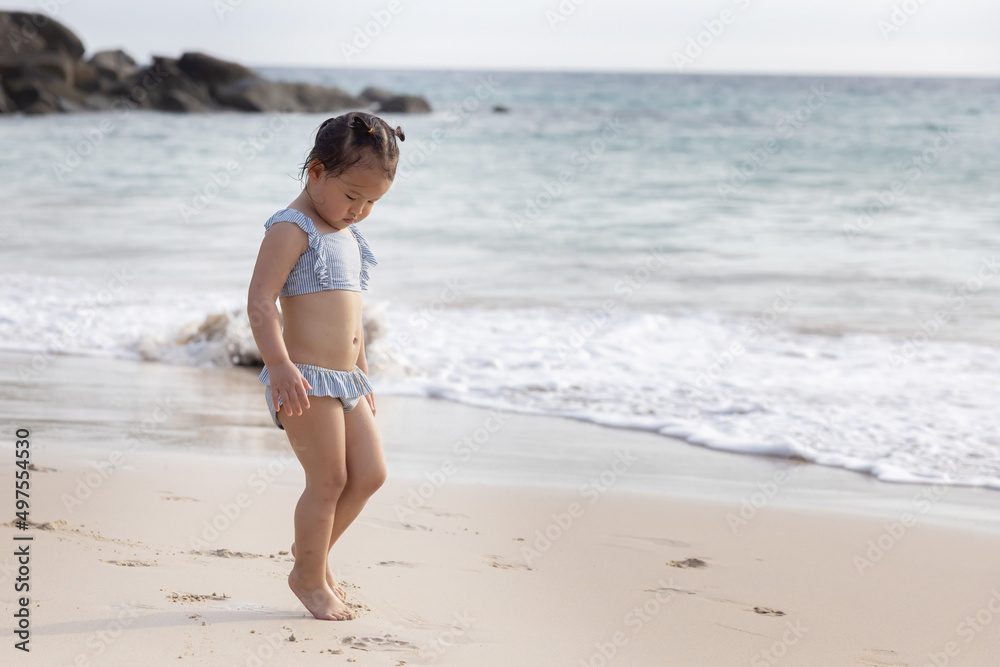 Cute Baby Girl in Bikini Walking on the Beach for Summer Vacation Cute Baby Girl in Bikini Walking on the Beach for Summer Vacation