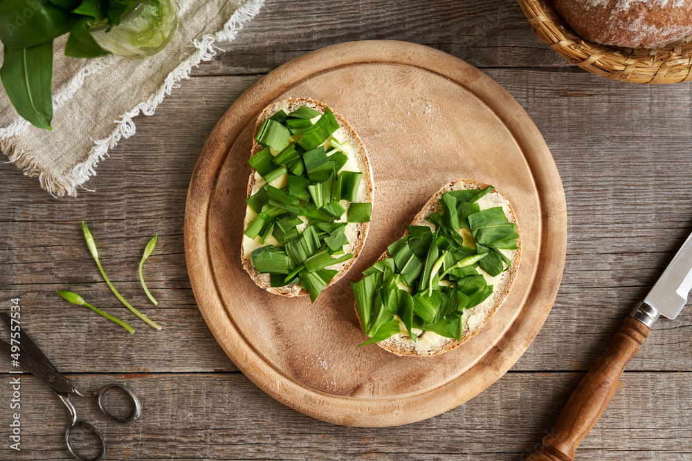 Slices of sourdough bread with butter and wild garlic Slices of sourdough bread with butter and wild garlic