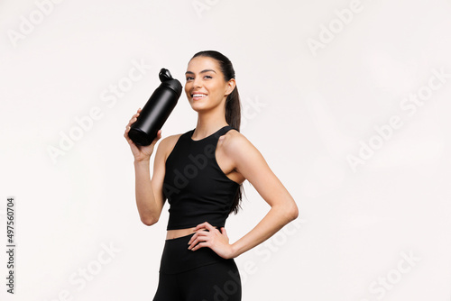 Latina Woman takes a water break during workout