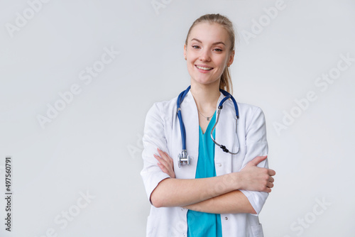 POrtrait of young caucasian woman therapist in uniform with stethoscope standing with crossed arms