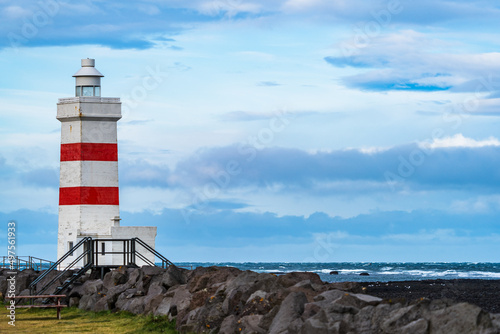 Lighthouse over the breakwater with rouch ocean photo