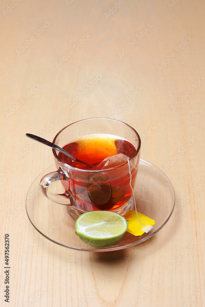 Cup of tea with tea bag, lemon on wooden table for dessert Cup of tea with tea bag, lemon on wooden table for dessert
