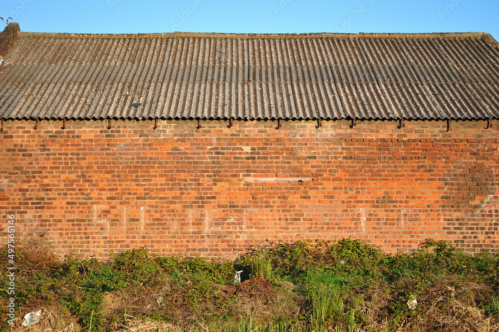 Brick Industrial Building with Corrugated Roof and Blue Sky Stock Photo ...