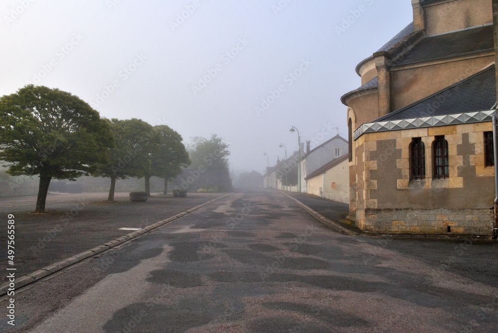 Misty Deserted Village Street with Church and Trees  