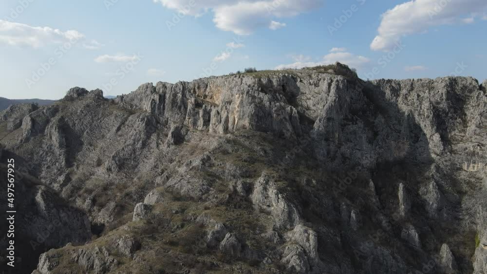 Aerial drone video over the hill mountain cliff with rocks of the Nisevac near Svrljig in Serbia in sunny day Aerial drone video over the hill mountain cliff with rocks of the Nisevac near Svrljig in Serbia in sunny day