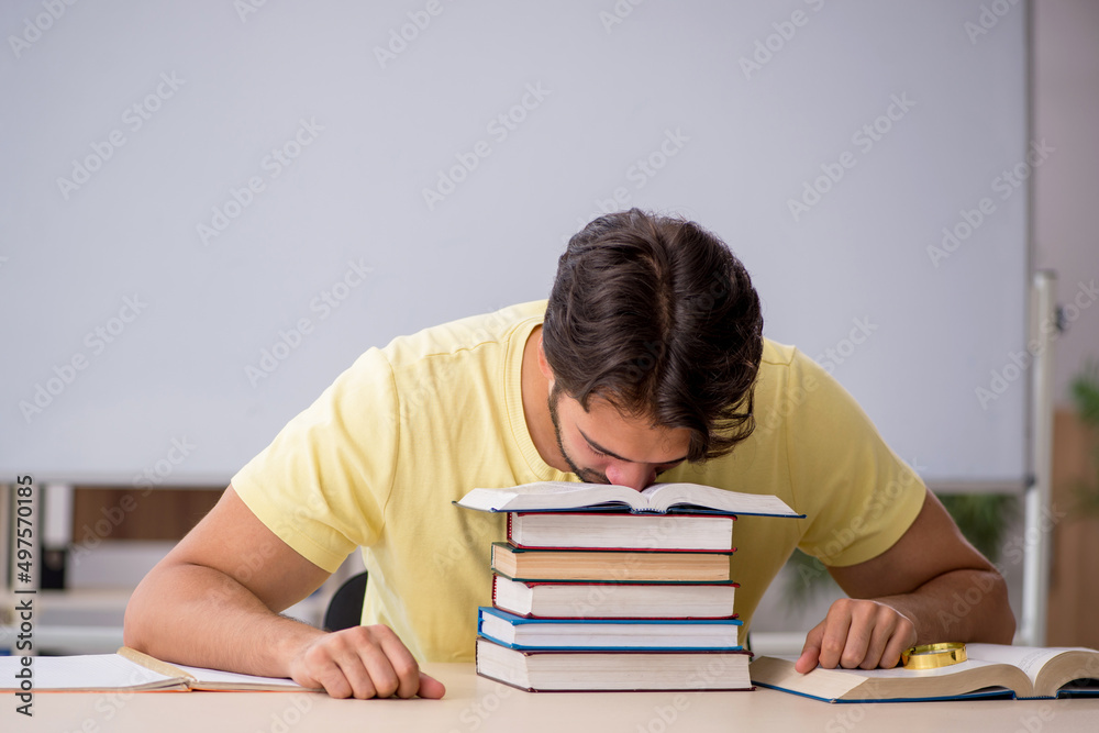 Young male student preparing for exams in the classroom Young male student preparing for exams in the classroom