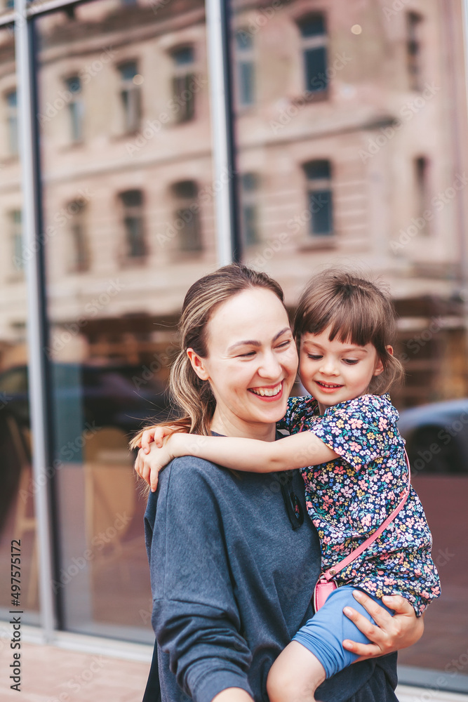 Young woman carrying her little daughter Young woman carrying her little daughter