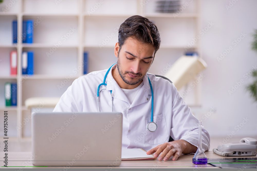 Young male doctor working in the clinic Young male doctor working in the clinic
