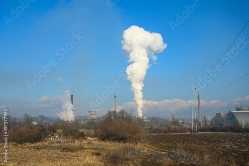 Heavy industrial air pollution from smokestacks. Toxic smoke from industrial area. Factory chimney blowing pollution in environment. 