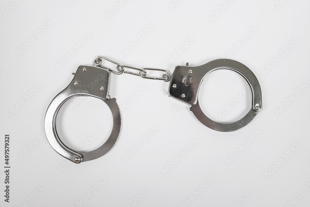 metal handcuffs on white metal handcuffs on white