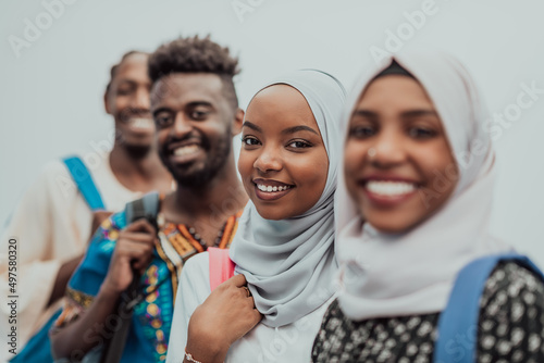 Photo of a group of happy african students talking and meeting together working on homework girls wearing traditional Sudanese Muslim hijab