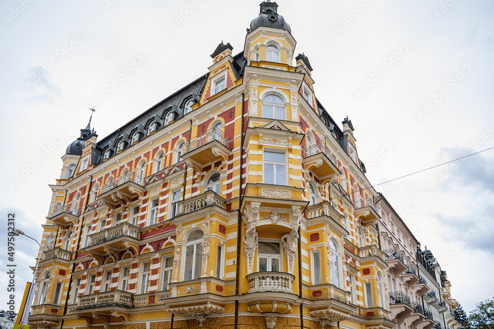Fototapeta premium Marianske lazne, Czech Republic, 7 August 2021: Romantic architecture of Bohemia, spa city Marienbad, colorful houses with beautiful facades of wellness hotel at sunny summer day, cultural monument