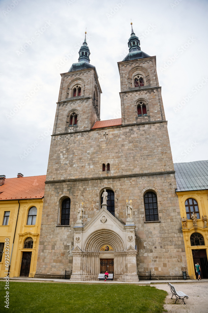 Tepla, Czech Republic, 7 August 2021: Premonstratensian Abbey and monastery, Romanesque church of the Annunciation with towers, gothic arched portal with stone carved statues of saints at summer day