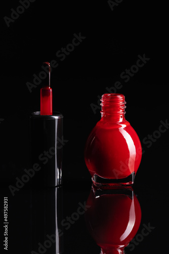 Colorful nail polish bottles on black table.