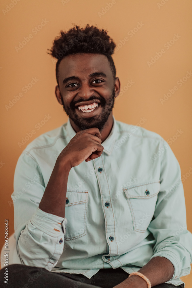 African student using laptop computer to study and make business connections yellow background African student using laptop computer to study and make business connections yellow background