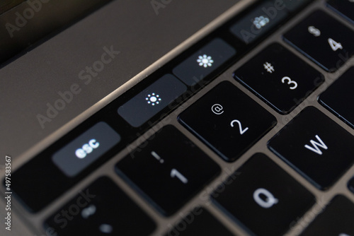 Closeup shot of details of a touch bar and a keyboard on a laptop photo