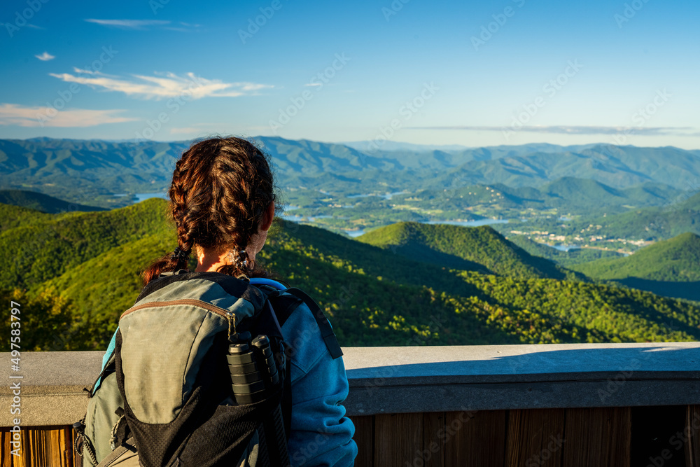 Woman hiker with braids enjoys the view from Brasstown Bald mountain peak