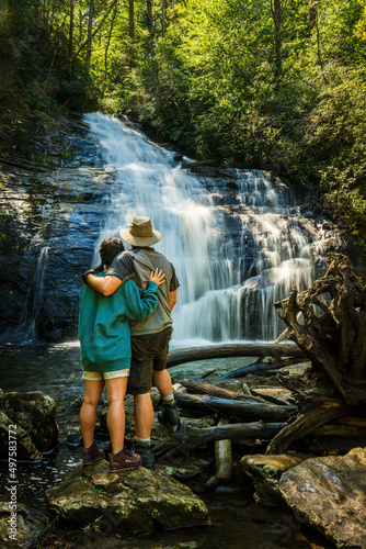 Hiking couple hugs at the base of Helton Creek Water Falls