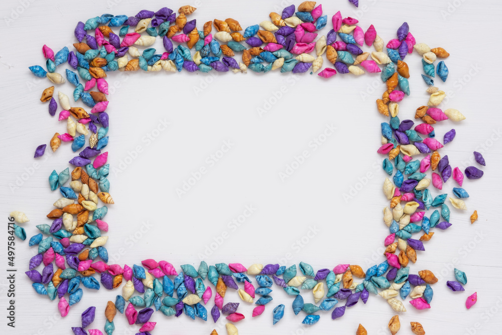 Multicolored seashells, top view. Background and texture. The concept of vacation, travel to the sea Multicolored seashells, top view. Background and texture. The concept of vacation, travel to the sea