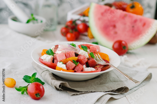Fresh salad with water-melon, tomatoes, feta cheese and mint.