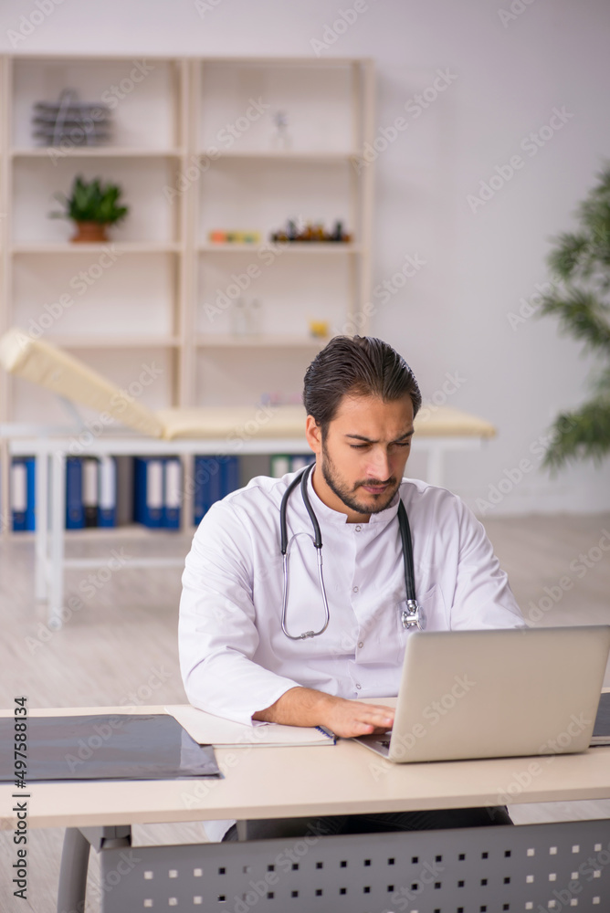 Young male doctor in telemedicine concept Young male doctor in telemedicine concept
