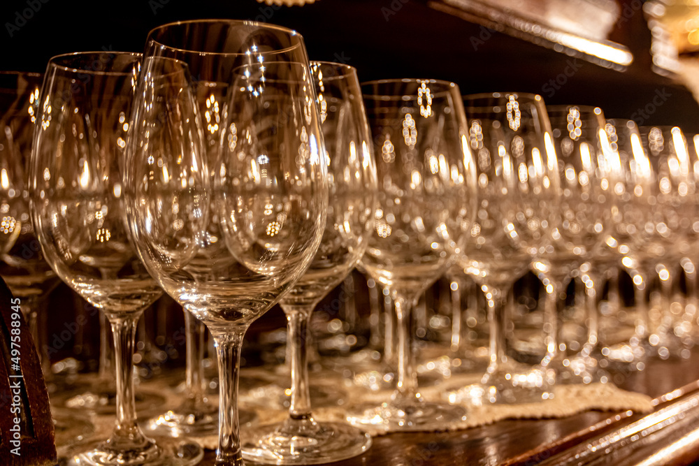 Wine glasses are on the table in front of the banquet. Wine glasses are on the table in front of the banquet.
