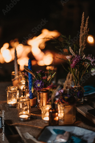 Vertical shot of candales and flowers on the table photo