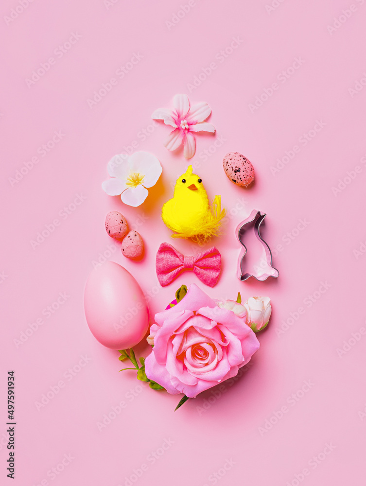 Easter egg shape made with pink rose, chicken, bow tie eggs and flowers on pastel pink background. Creative Easter holiday concept. Minimal traditional greeting card. Flat lay. Easter egg shape made with pink rose, chicken, bow tie eggs and flowers on pastel pink background. Creative Easter holiday concept. Minimal traditional greeting card. Flat lay.