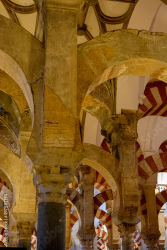Medieval moorish architecture, colorful achways with columns in old mosque in Cordoba with no people, Andalusia, Spain © barmalini