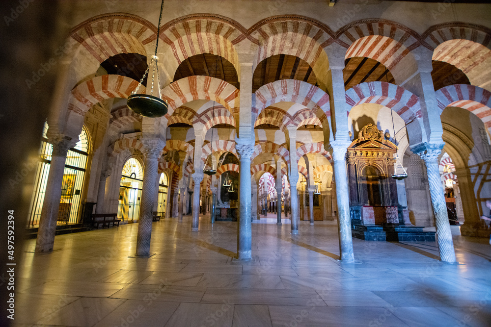 Fototapeta premium Medieval moorish architecture, colorful achways with columns in old mosque in Cordoba with no people, Andalusia, Spain