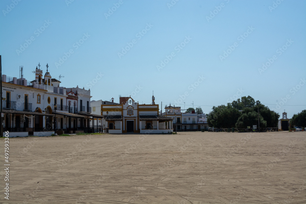 White houses and sandy street in small town El Rocio in Donana National park in Andalusia, Spain