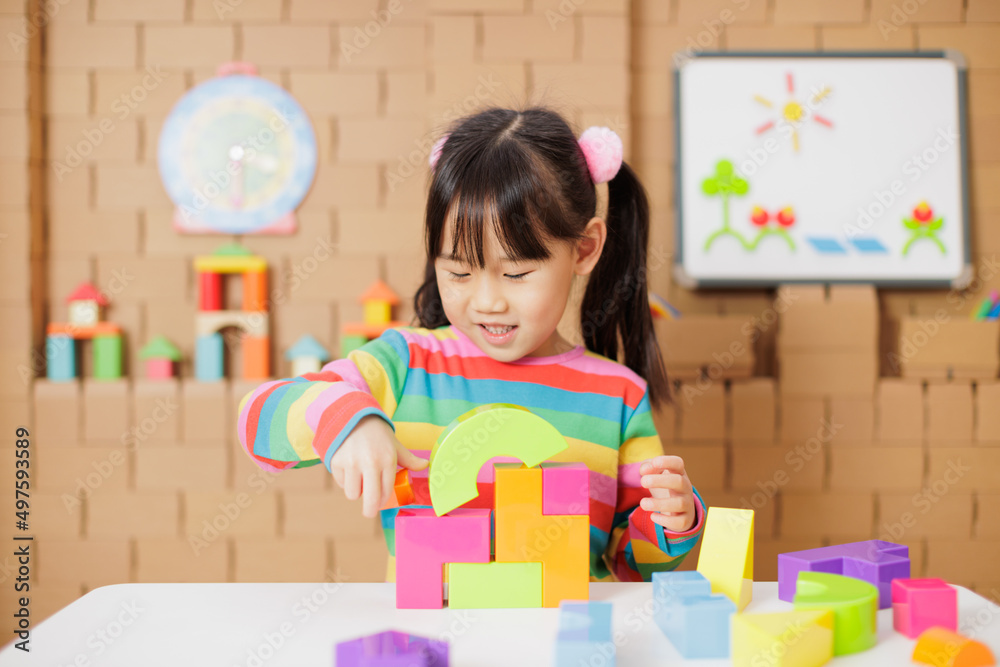 young girl playing creative toy blocks at home young girl playing creative toy blocks at home