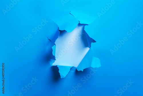 Bilde på lerret Blue papper with hole isolated background with copy space