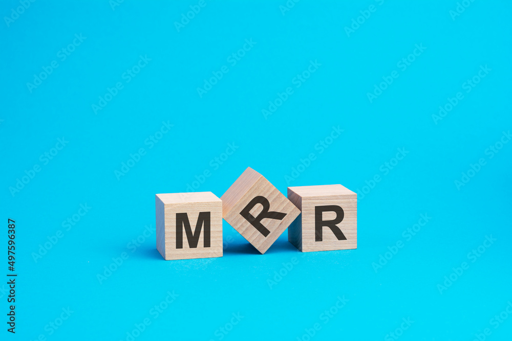 wooden cubes with letters MRR, blue background, business concept wooden cubes with letters MRR, blue background, business concept