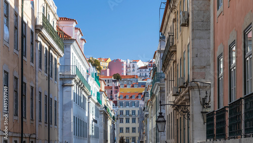 Street of the Alfama district, the oldest neighborhood of Lisbon with traditional houses and paved road, Portugal, Europe