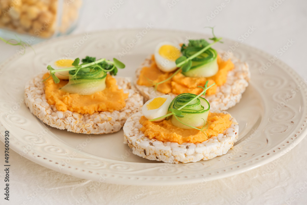 Plate with crispbreads and tasty hummus on white background Plate with crispbreads and tasty hummus on white background