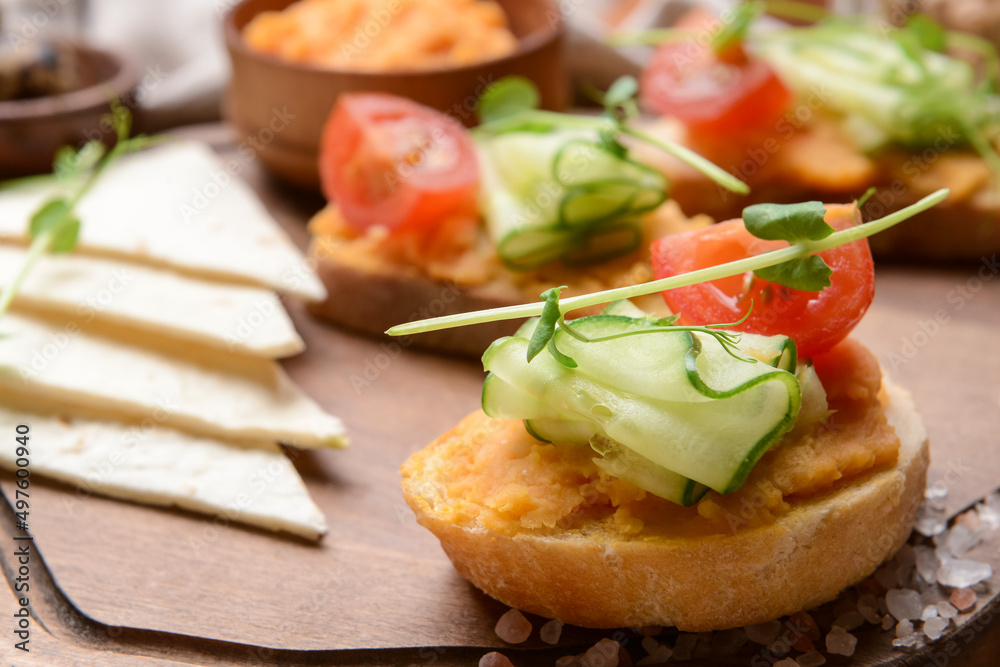 Board with piece of bread and tasty hummus, closeup Board with piece of bread and tasty hummus, closeup
