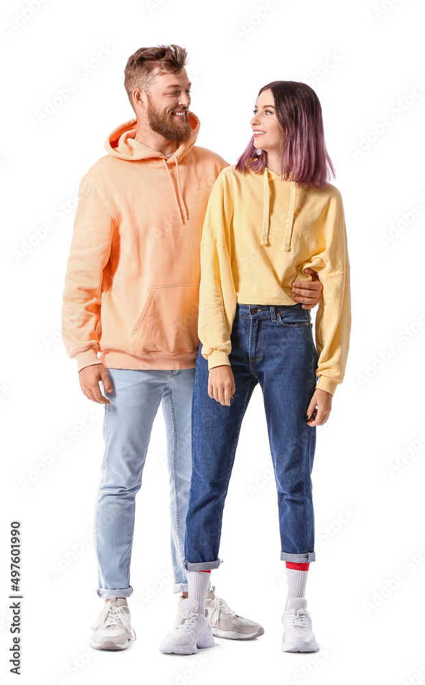 Cool young couple in hoodies on white background