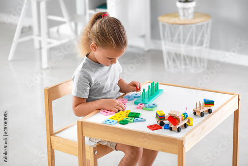Cute little girl playing wi...
